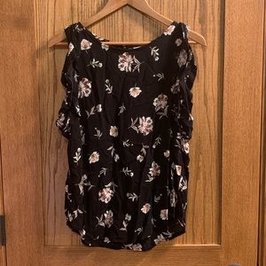 Women’s blouse with sleeveless ruffled detail.
